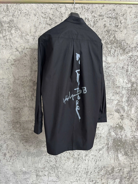 A simple long-sleeved single-breasted shirt with a double-layered collar, solid color and asymmetrical design