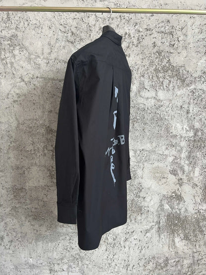 A simple long-sleeved single-breasted shirt with a double-layered collar, solid color and asymmetrical design